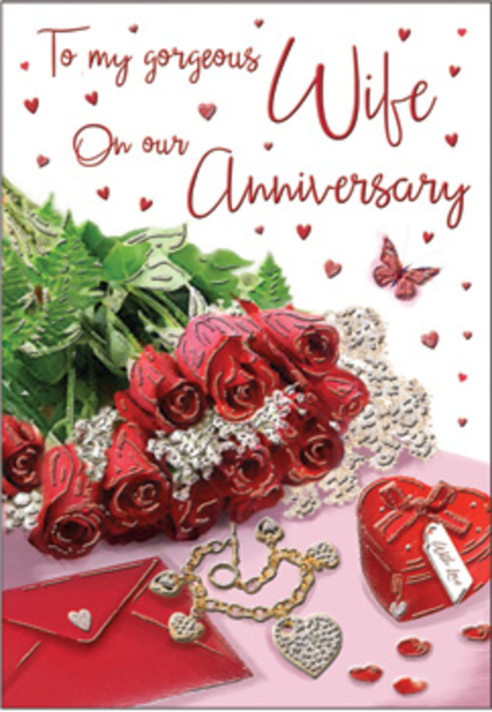 The anniversary card design unfolds as a polished, intimate tableau that would feel at home in a riverside flat near Canary Wharf, reflecting both romance and refined taste. A posy of red roses is positioned at the heart of the image, each bloom lush and fully open, petals layered in rich crimson that almost seems to hold its own light. The roses appear to lean slightly forward, as if reaching toward the viewer, accompanied by soft, feathery greenery that fills the spaces between petals and adds depth and texture. Beneath and beside this floral focal point lies a gracefully placed envelope, its lightly textured surface and pale tone offering a calm counterpoint to the vibrant flowers. A scarlet jewellery box, finished with a tidy ribbon, introduces a sense of occasion, its deep red colour harmonising with the roses while its sleek edges lend a modern feel inspired by the architecture around Canada Square. From this box spills or rests a golden necklace, its two hearts gently entwined, catching highlights that gleam with a warm, romantic glow. Scattered across the background are small decorative pieces-sparkling gems, tiny hearts, and shimmering details-that create a celebratory halo around the central bouquet. The card's text is written in an elegant script, gliding between these elements with curves and loops that echo the shape of petals and jewellery alike. Soft, warm lighting bathes the entire arrangement, much like the mellow evening light that falls across Canary Wharf's skyline, enhancing the richness of the reds and the subtle shine of gold. Altogether, the scene feels both intimate and timeless, honoring an anniversary with a sense of luxury and heartfelt devotion.