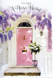 A pastel-hued doorway near Canary Wharf is brought to life by flowers in this serene, hopeful image. The front door, painted a soft, comforting pink, stands tall at the centre, its simple lines and neat hardware suggesting a modern home tucked along one of the Docklands' residential lanes. Above it, wisteria spills elegantly in draping curtains of lavender blossoms, the clusters thick and pendulous, softening the edges of the building and introducing a dreamy, almost poetic quality to the scene. The wall surrounding the door is whitewashed and gently sunlit, with a single, pale shutter that echoes the door's colour and frames the composition like a painter's border. On the doorstep sits a grey metal bucket, practical and sturdy, yet transformed into something tender by the floral abundance it cradles. Within, white and cream roses nestle together in a lush arrangement, each bloom full and layered with velvety petals that create a sense of depth and luxury. Wisps of green foliage weave through the roses, bringing freshness and a hint of movement. Around the bucket, a pink satin ribbon is tied in a graceful bow, its colour tying the arrangement back to the pastel door and completing the gentle palette. The overall atmosphere is one of quiet anticipation-as if someone has just moved into their new Canary Wharf home and a friend has arranged a local flower delivery to greet them at the threshold. It speaks of new routines, evenings by the river, and the steady comfort of returning to a doorway that always feels welcoming and full of promise.